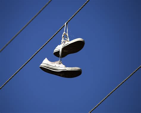 why are there shoes on power lines